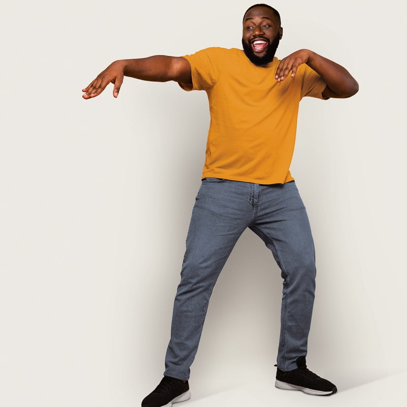 black man with orange shirt and grey trousers who put both arms in one direction