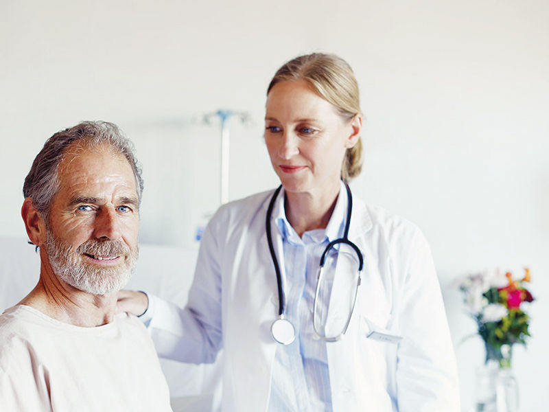 Male patient in a hospital with a female doctor laughing together