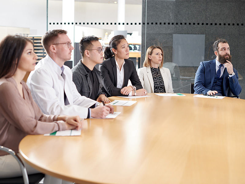 Hospital managers sitting at a table in a training