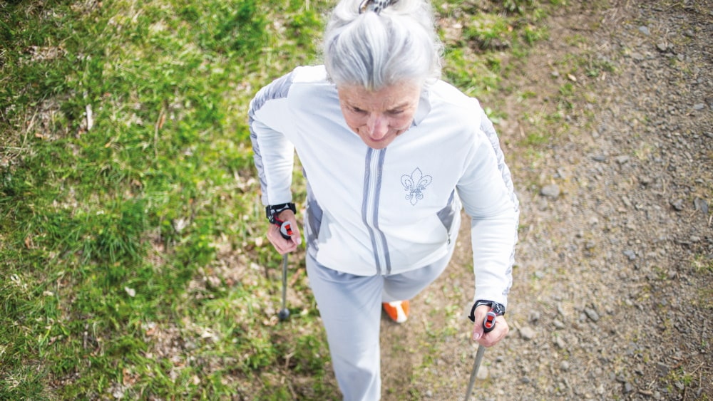 eldery woman does nordic walking